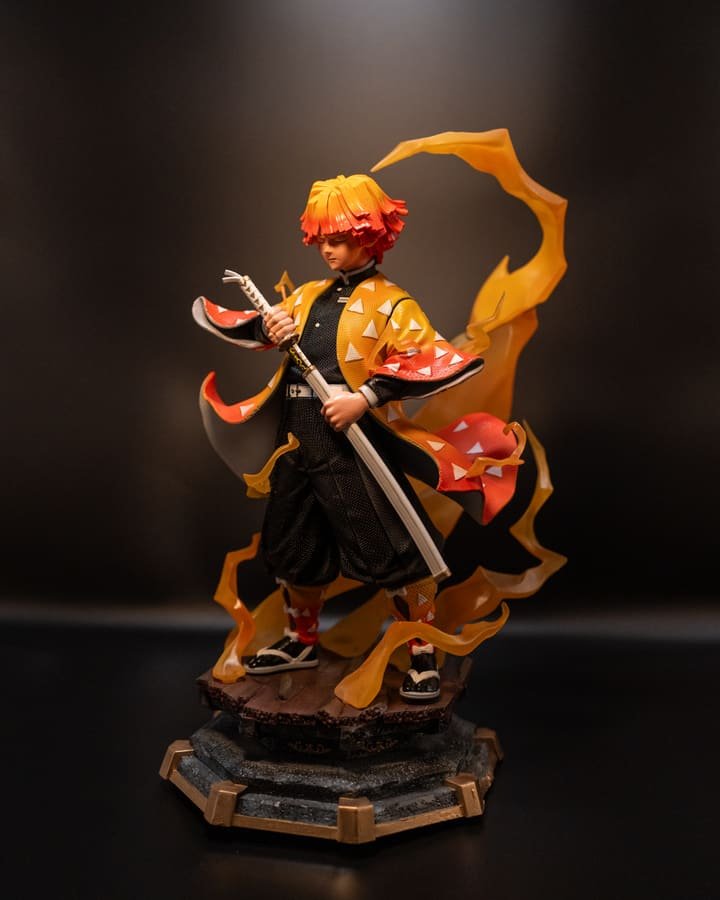 Zenitsu figurine from Demon Slayer drawing his katana, wrapped in translucent lightning effects, on a stone and gold display base